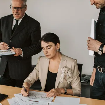 People reviewing business documents at an office table
