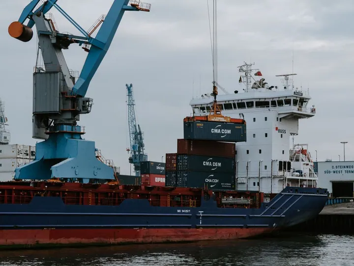 Container ship beside cranes at a port