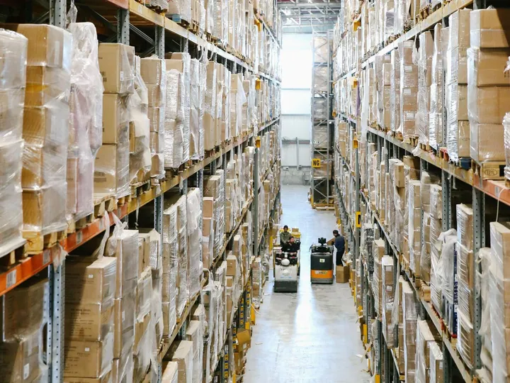 Shelves of boxes in a warehouse aisle